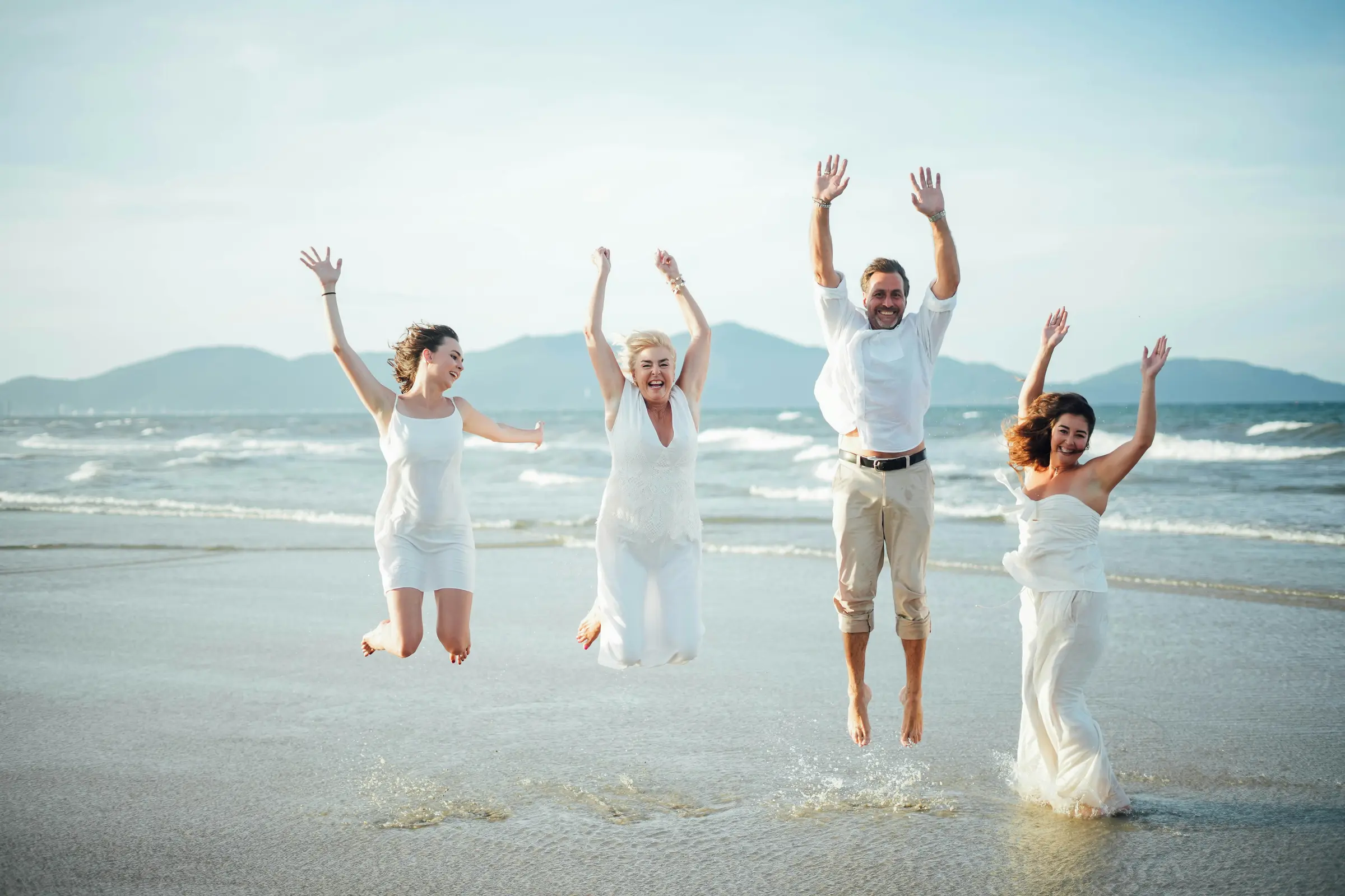 People jumping together on a beach